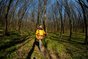Male hiker looking to the side walking in forest