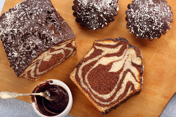 Swirl cake with chocolate on wooden board