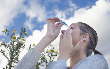 using eyedropper to treat irritated eyes