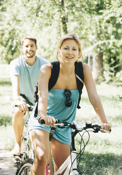 Happy couple riding bicycle