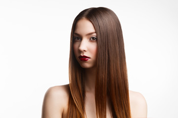 Fototapeta premium Beauty portrait of young brunette woman with red lips on white