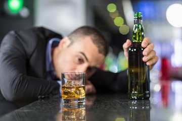 Image result for drunk at bar in front of a bottle