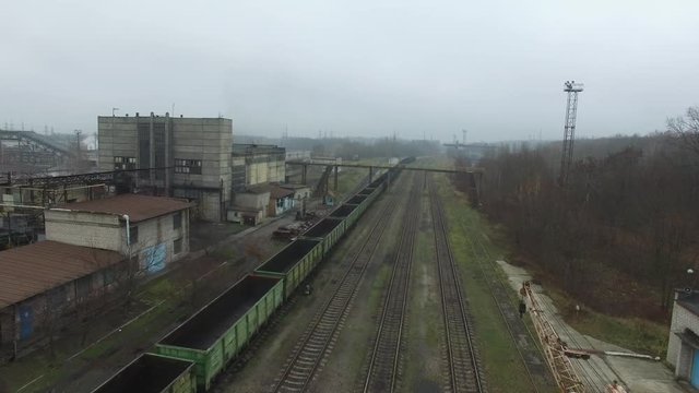 4k Aerial footage of a freight trains on a railroad station