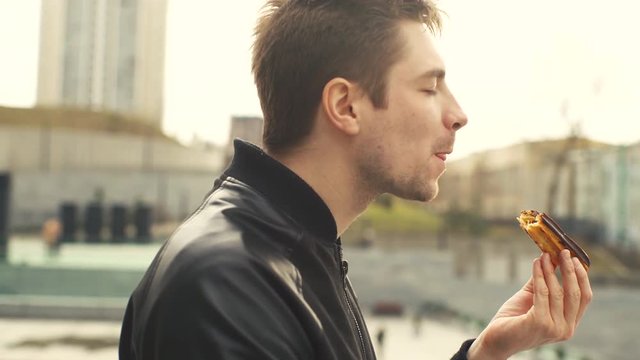 Man Eating Eclair on the Street