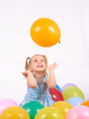 Little girl playing with balloons. - 108049179