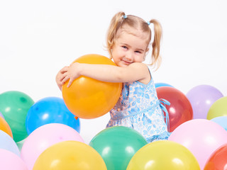 Little girl playing with balloons.