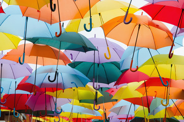 Fototapeta na wymiar colourful umbrellas hanging on the sky