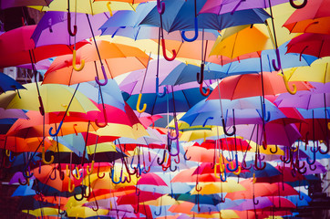 Colorful umbrellas hanging above the street © Alfonsodetomas