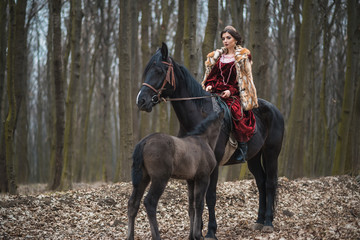 Princess with her horse in the woods