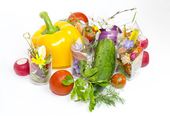 mini canapes in plastic cups decorated with edible flowers