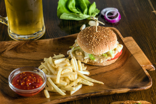 burger with fries and a cold beer