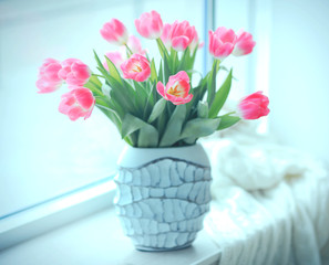 Bouquet of fresh tulips on windowsill