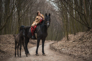 Princess with her horse in the woods