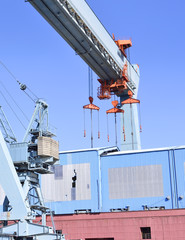 Fototapeta premium Wharf or shipyard of Hamburg Harbor, Germany. Harbor cranes and production halls at a commercial dock. Industry buildings.