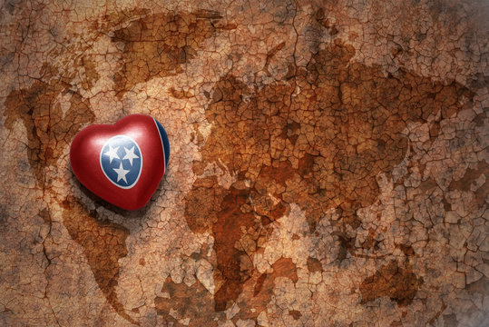 heart with tennessee state flag  on a vintage world map crack paper background