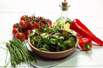 Fresh green salad with spinach ,ruccola,lettuce on wooden table.