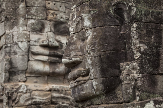 Two stone carved faces in Bayon temple, Angkor Thom, Cambodia