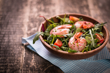 Green salad with shrimps on wooden table.healthy food