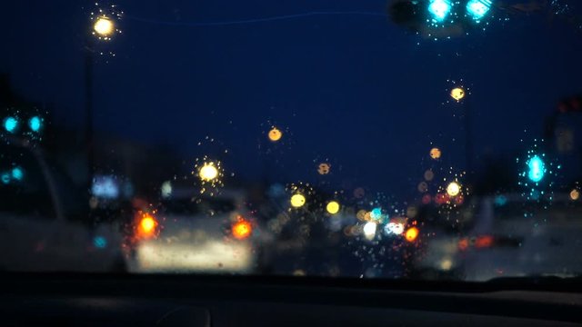 Rainy Dark Night view From Inside a Car of Wipers Movement at a Red Light
