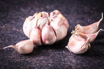 garlic bulbs with garlic cloves on wooden table,soft focus