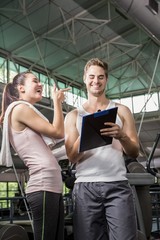 Happy woman talking to her trainer after a workout