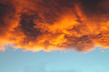 Orange and Gold Cloud at Sunset Against a Blue Sky