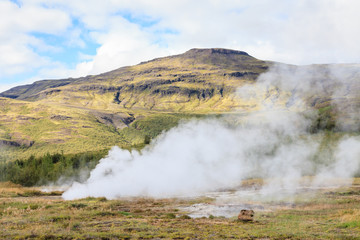 Geysir Geothermal Field.  Steam rises from a sulphur pool at the Geysir Geothermal Field and located in Haukadalur in Iceland.  The tourist attraction is part of the Golden Circle tourist trail.