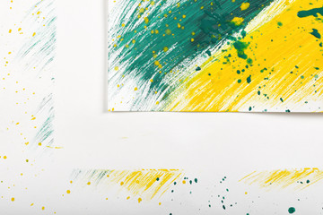 Corner of yellow-green abstract sketch on white background with hand-painted gouache brush traces