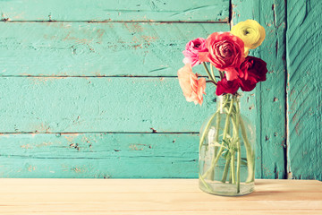photo of spring flowers on wooden background. vintage filtered
