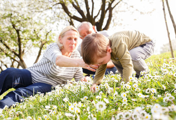 Fototapeta premium Grandparents with grandson enjoying the sunny spring day outdoors.