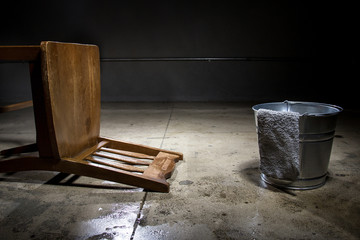 Torture chamber with a water bucket for controversial waterboarding