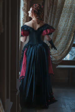 Woman in Victorian dress back.