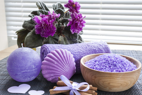 Lavender bath salts with flowers, cinnamon, soap and towel