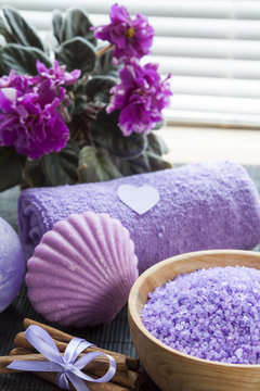 Lavender bath salts with flowers, cinnamon, soap and towel