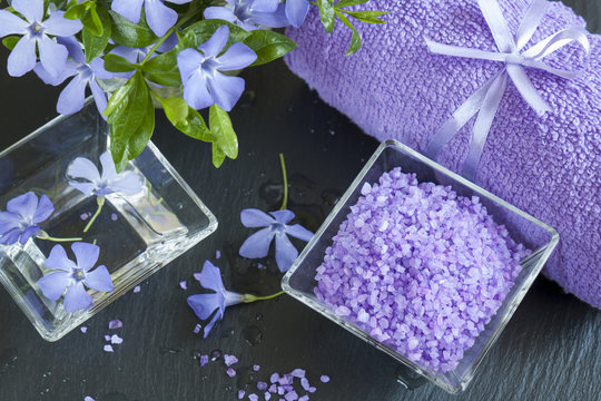 Lavender bath salts with flowers and towel