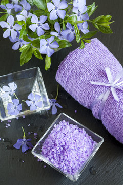 Lavender bath salts with flowers and towel