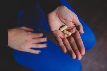 Closeup of a hand holding pills