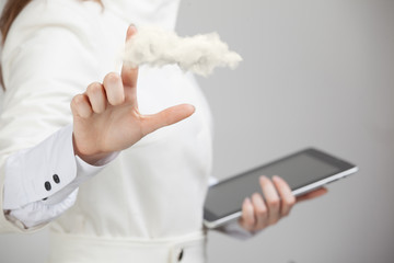 Young woman holding tablet and cloud, cloud computing concept