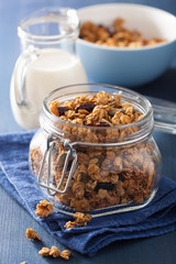 homemade healthy granola in glass jar and milk