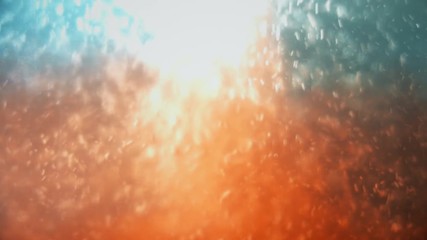 Adding orange Liquid into Transparent Fluid and creating bubbles.