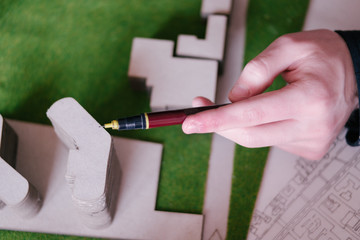 Architect working on blueprint. Architects workplace - architect