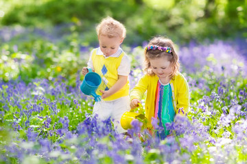 Kids in a garden with bluebell flowers