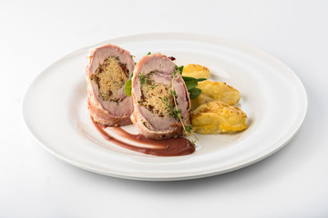 Roasted pork roll stuffed with rice and potatoes with cheese