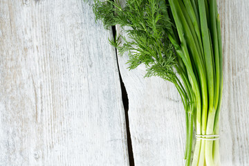 spring onion and fresh dill on wooden surface