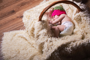 charming sleeping baby in a basket