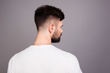 Close up portrait of man's back isolated on gray background © deagreez