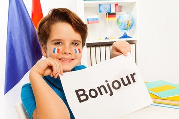 Smiling boy learning French at the classroom © Sergey Novikov