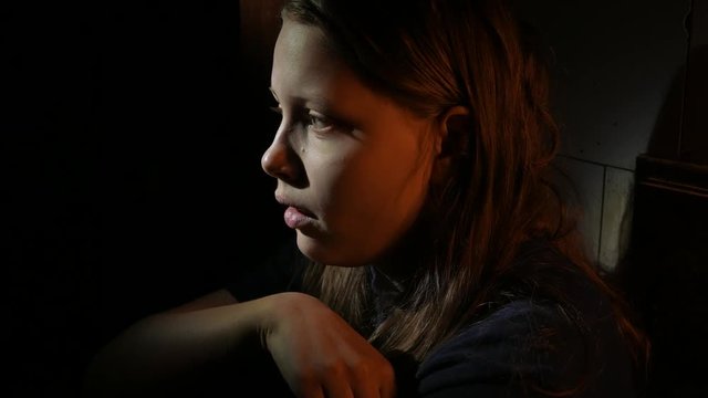 Domestic violence, portrait of abused and hurt young teen woman crying at home. 4K UHD