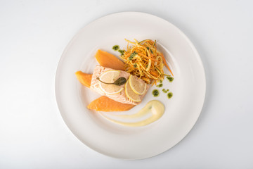 Grilled salmon, mango and salad on a plate