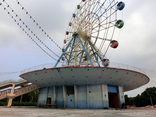 Abandoned old colorful Ferris wheel in Chinese amusement park - landscape color photo